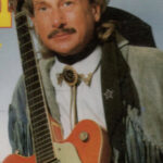 William W. de Zingende Cowboy met gitaar