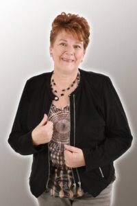 Zangeres Anita van de Rapsodie's in een zwart jasje